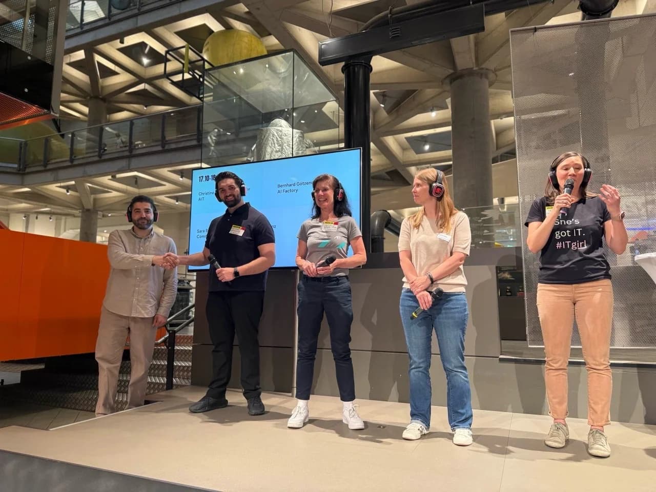 Bernhard Götzendorfer on stage at the Future Fit Festival in the Technical Museum Vienna, wearing wireless headphones.